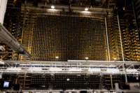 Inside Hanford’s B-Reactor, a large wall of metal instruments under lights,