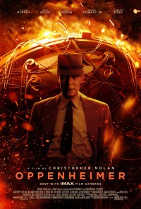Image of the 2023 film Oppenheimer cover. Image is covered in a red hue and depicts actor in center stage with machinery, likely atomic bomb related. The word Oppenheimer is listed on the bottom in clear, uppercase red font.