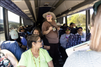 Yakama Nation ERWM’s Rose Ferri on a charter bus with Yakama Nation Tribal School and Heritage University students as they tour onsite at Hanford for the 3rd annual Hanford Journey event. 