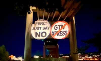signs that say "FERC JUST SAY NO" and "GTN XPRESS" with a red strike through the words